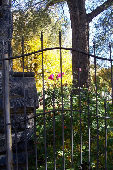The iron gate at the cemetery entrance archway.