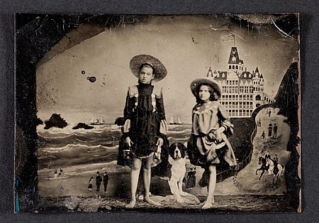 Tintype of two girls in front of a painted background of the Cliff House and Seal Rocks in San Francisco, circa 1900
