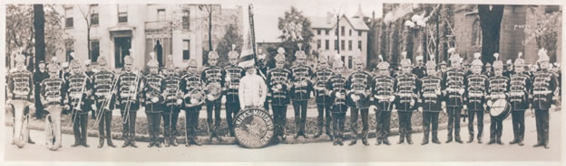 Kirk’s Military Band while on tour in Columbus, Ohio. Diminutive William Kirk stands at the center, dressed in white, partially hidden by the famous bass drum that reads, “KIRK’S MILITARY BAND, CLEVELAND, OHIO.”